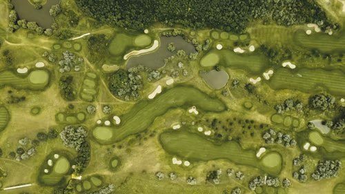 Aerial view of a golf course with fairways, bunkers and ponds