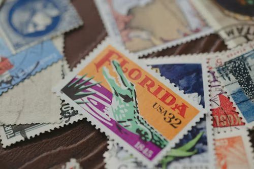 A pile of vintage postage stamps, one marked Florida